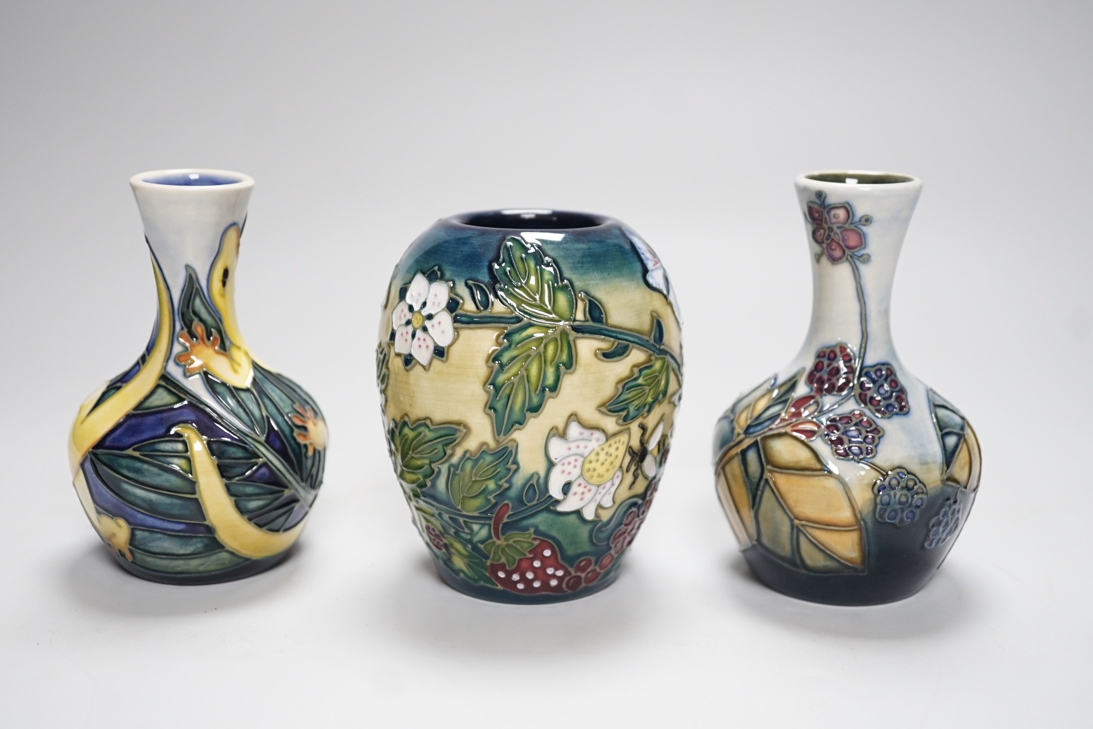 Three boxed Moorcroft small vases, Rarotonga Lizard, Bramble, etc., tallest 10 cm